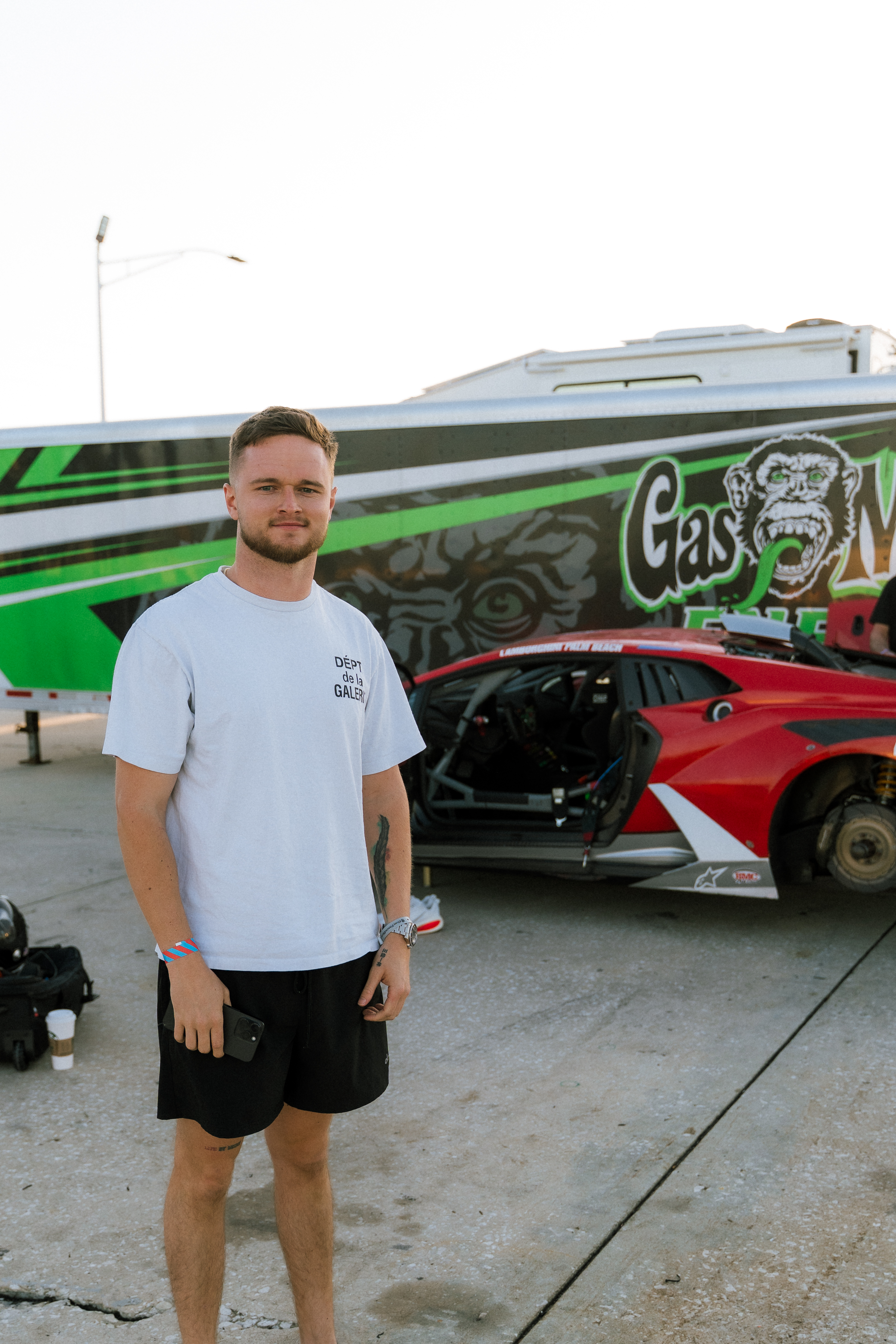 Dawson Gant beside a race car at the track